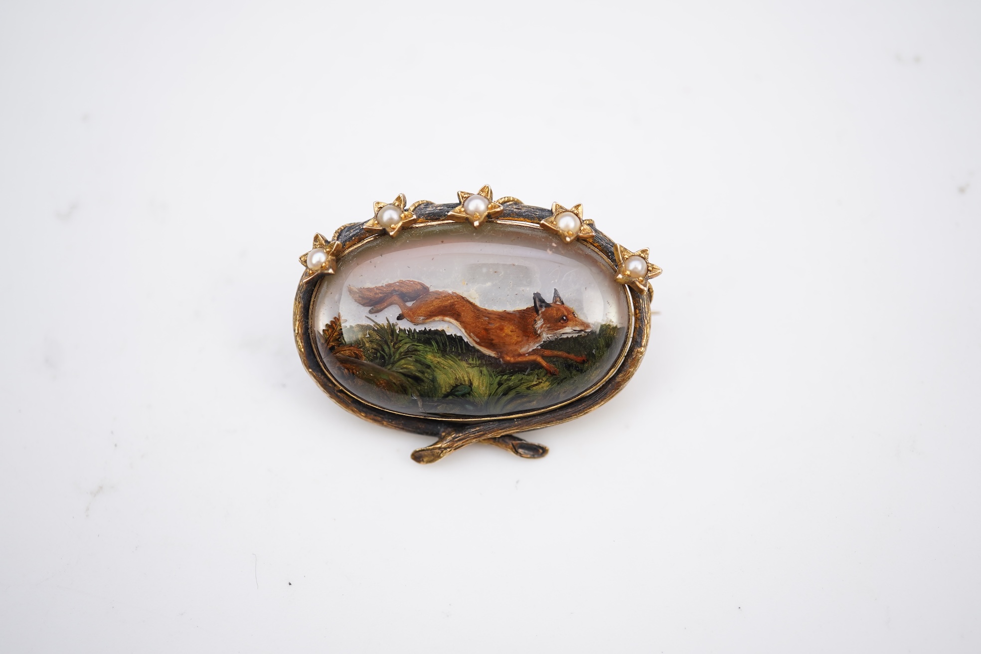 A reverse-carved and painted intaglio 'Essex crystal' brooch, late 19th century